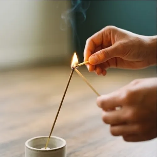 Lighting a stick of incense